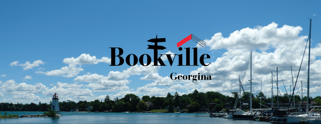A graphic reading Bookville: Georgina. The text is set over a sky with fluffy white clouds. You can see Jackson's Point Lighthouse, based in Georgina, at the bottom of the image.