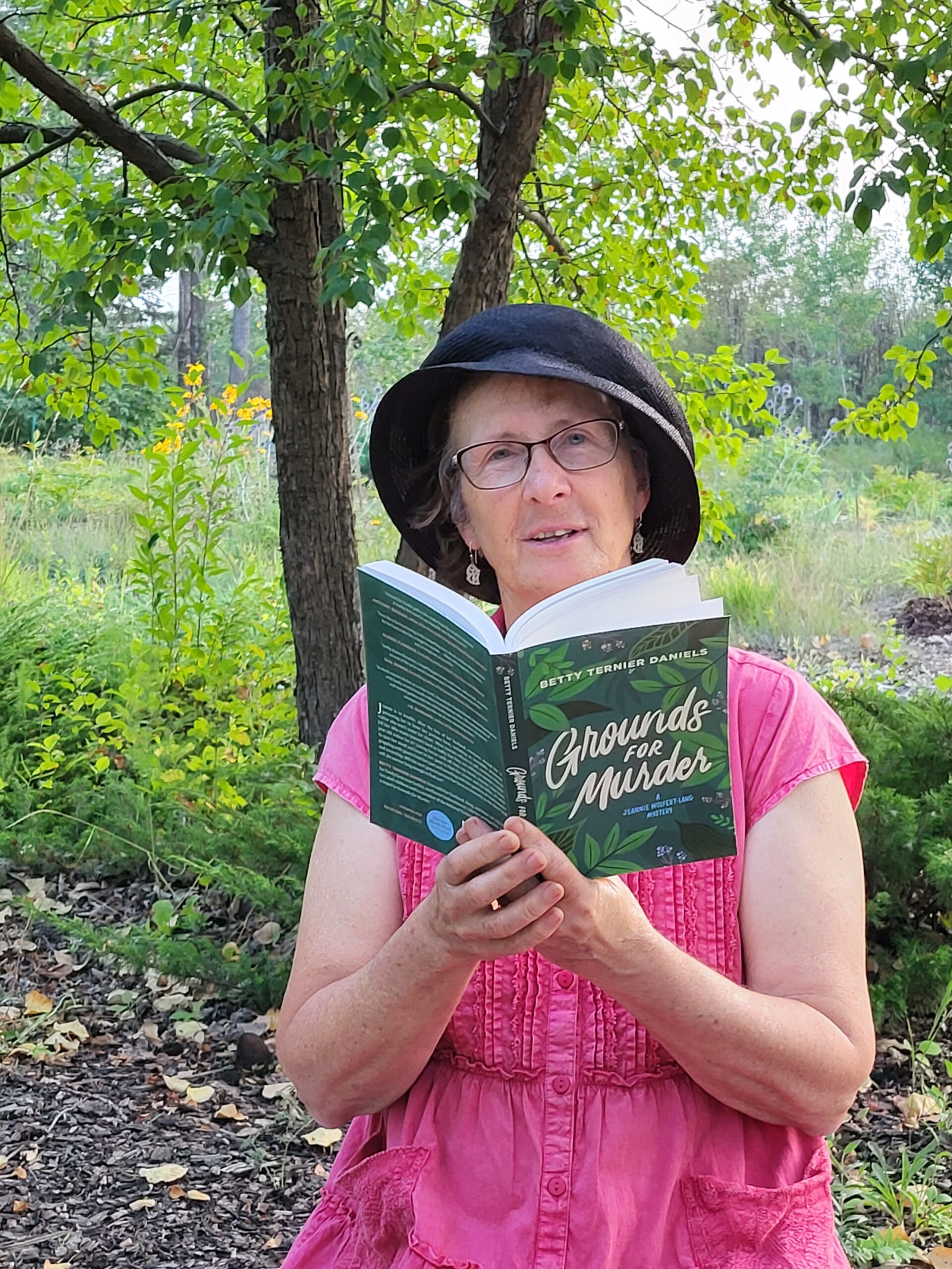A photo of Betty Ternier Daniels at the edge of a half-wild landscaped area just south of her house in the northwest Saskatchewan rural municipality of Meota.