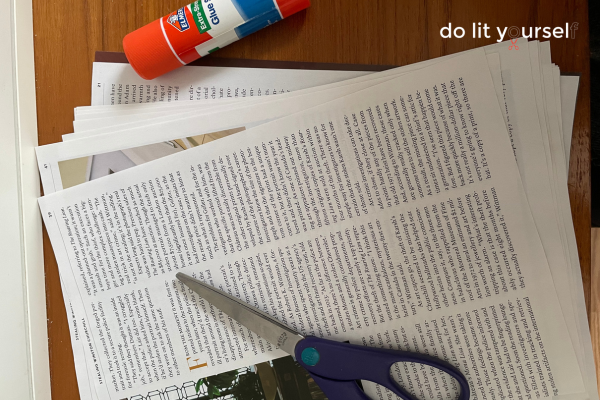 Materials for this craft, laid out on a wood table. Pages from a magazine, a pair of scissors, and a glue stick.
